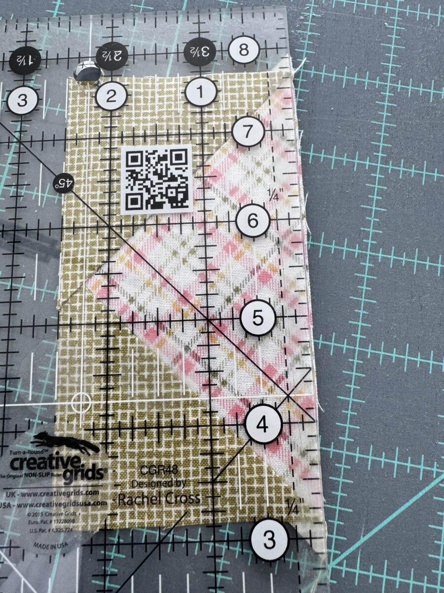 Rotated flying geese 180 degrees to trim the other long side using the 2.5 inch mark on ruler