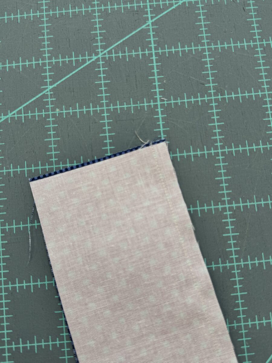 Two fabrics sewn together with edges misaligned due to fabric shifting while sewing