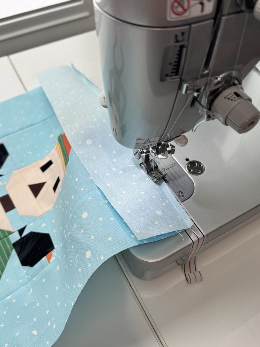 Large quilt block hanging off sewing machine without extension table support