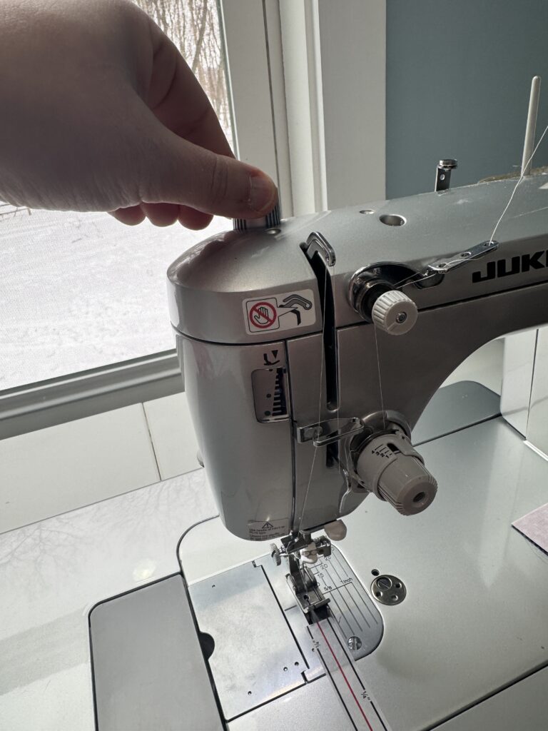 Presser foot pressure adjustment knob on a Juki sewing machine