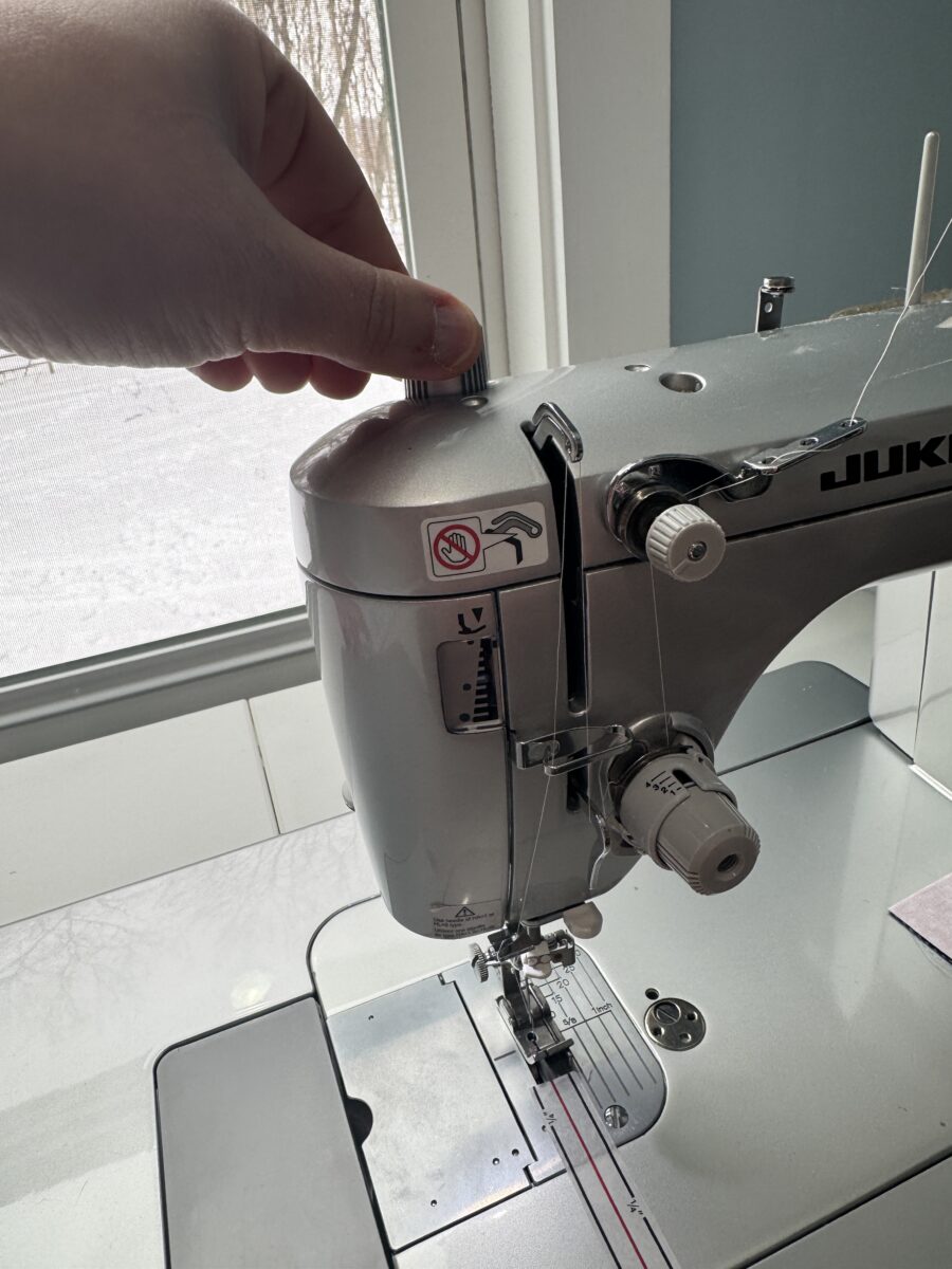 Presser foot pressure adjustment knob on a Juki sewing machine