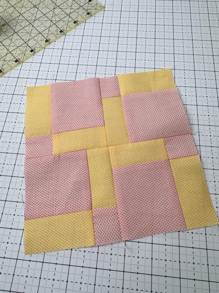 A finished disappearing nine patch with thin pieces making a pinwheel center