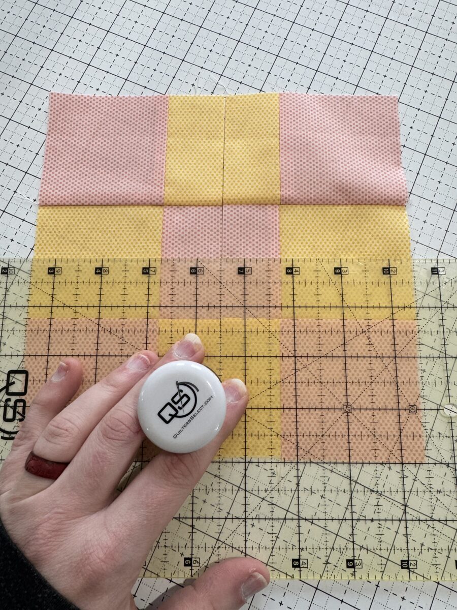 cutting a horizontal line in the nine patch block to have 4 pieces