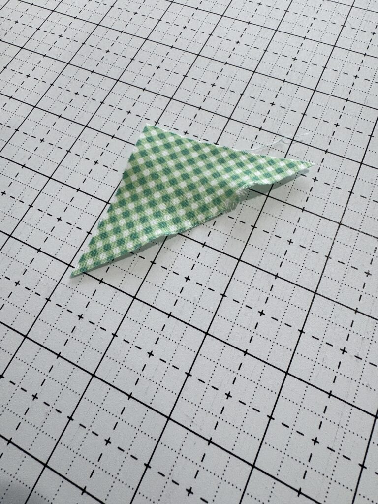 A bias cut half square triangle stretched out of shape