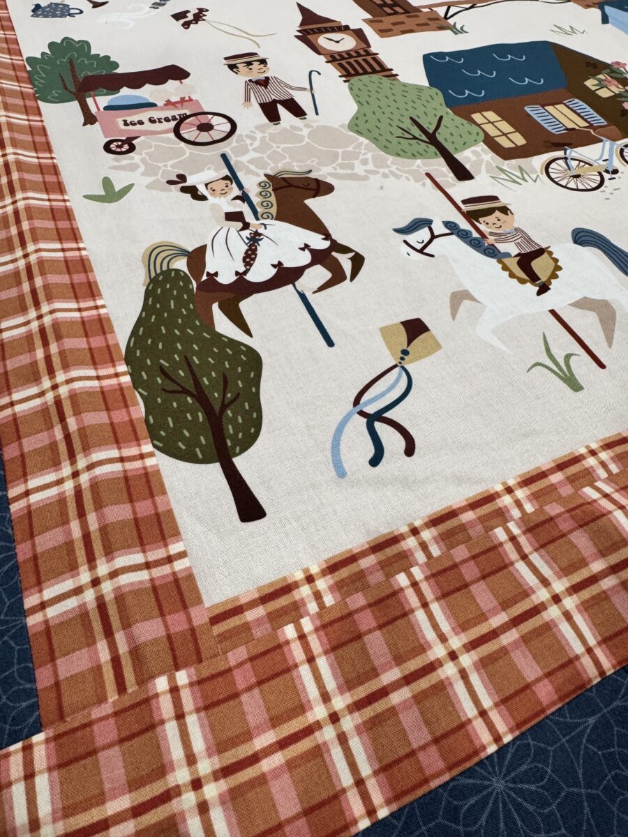 Corner of quilt panel showing sashing and filler fabric blended together