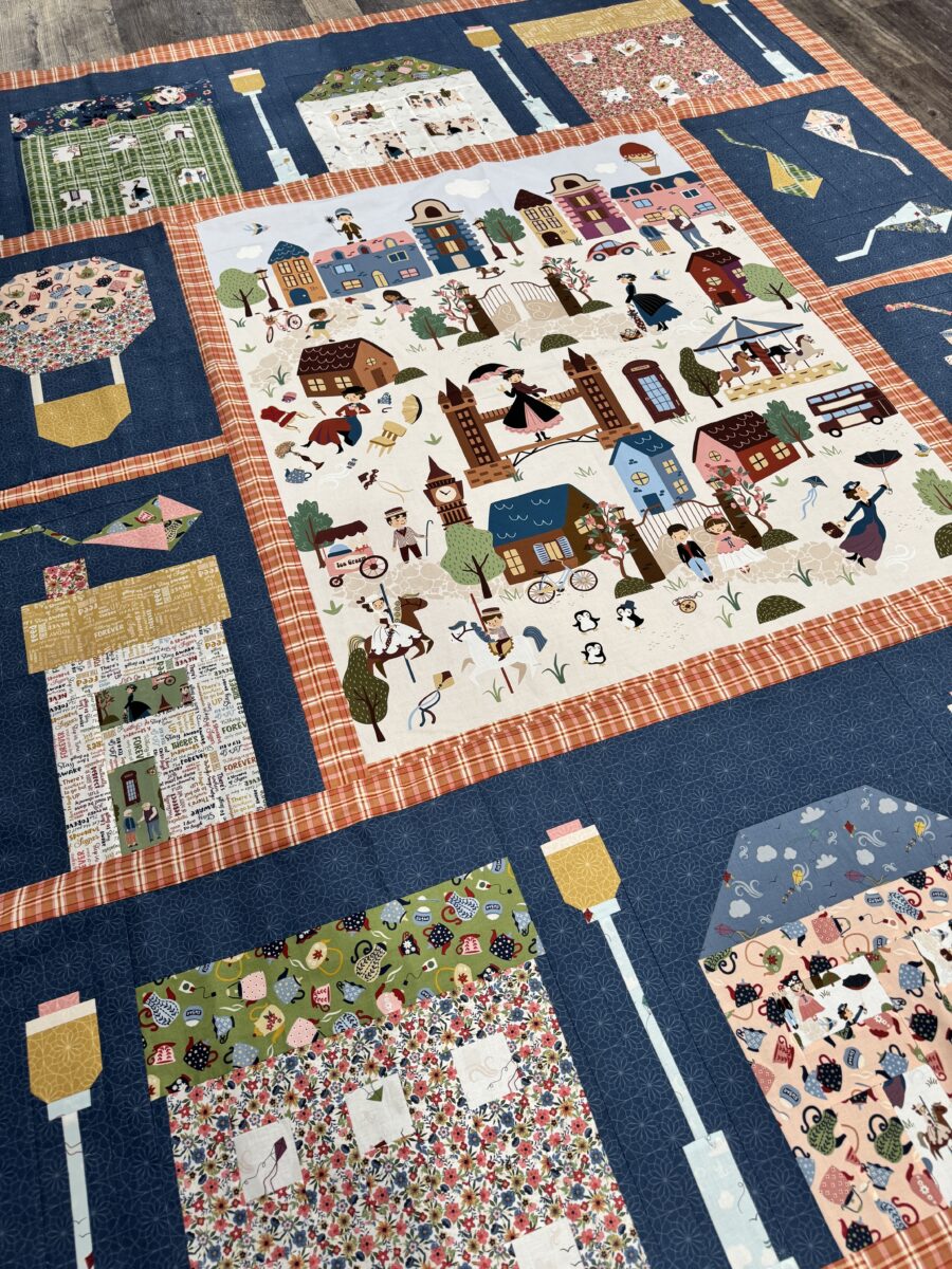 Angled view of quilt top showing house blocks, kites, and sashing layout