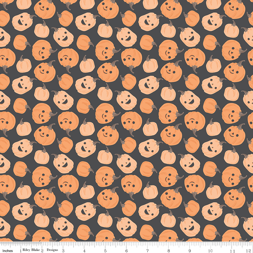 Frank and Friends Pumpkins Charcoal fabric with smiling pumpkins on dark background