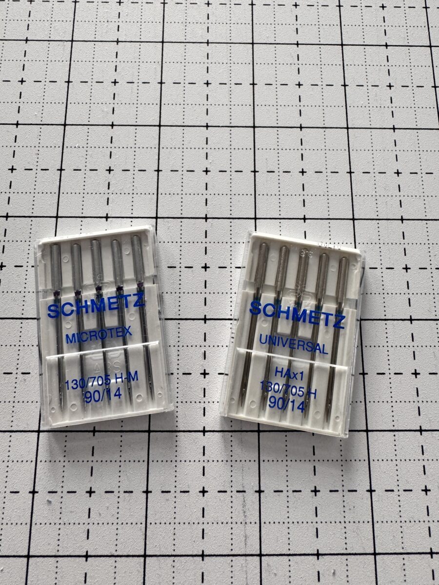 Two Schmetz needle packs size 90 showing Universal and Microtex needles for different sewing purposes