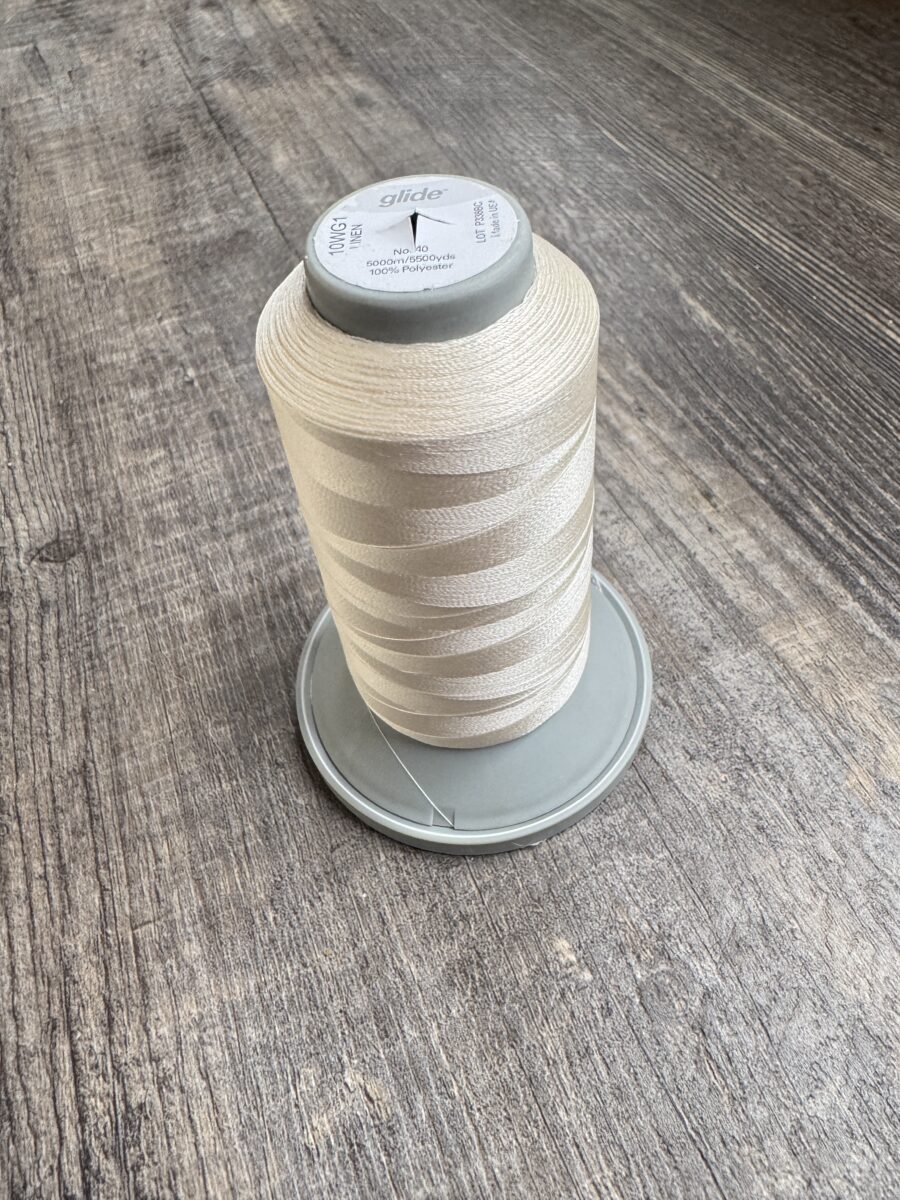 Glide thread cone used for long arming.  It is a polyester thread with a slight sheen. 