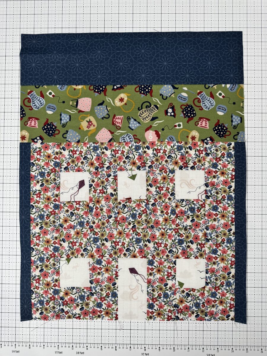 House quilt block with green teapot print roof and white floral house with kite print windows