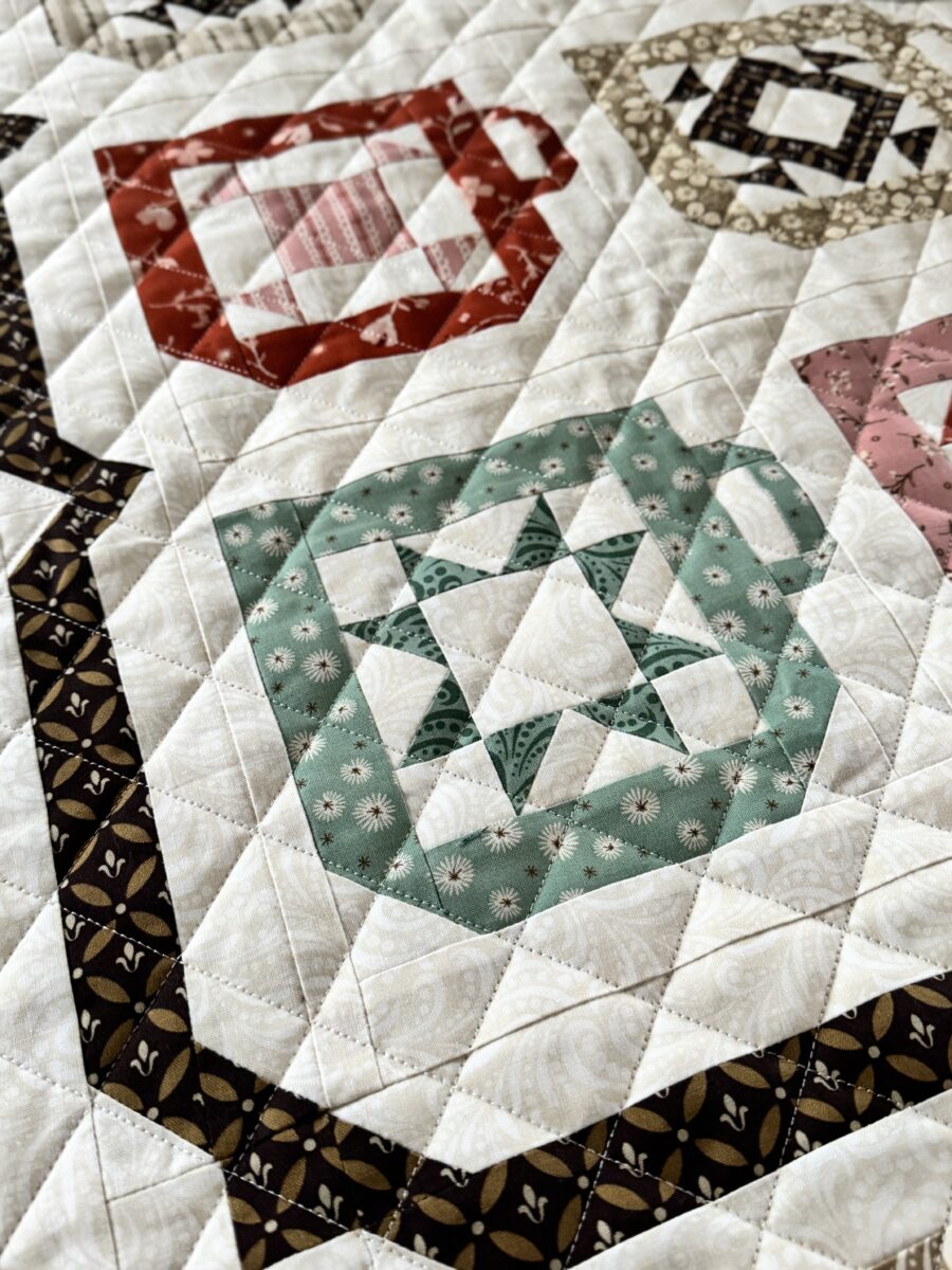 Close up of cross hatch quilting on coffee mug quilt block made with Morning Latte fabric
