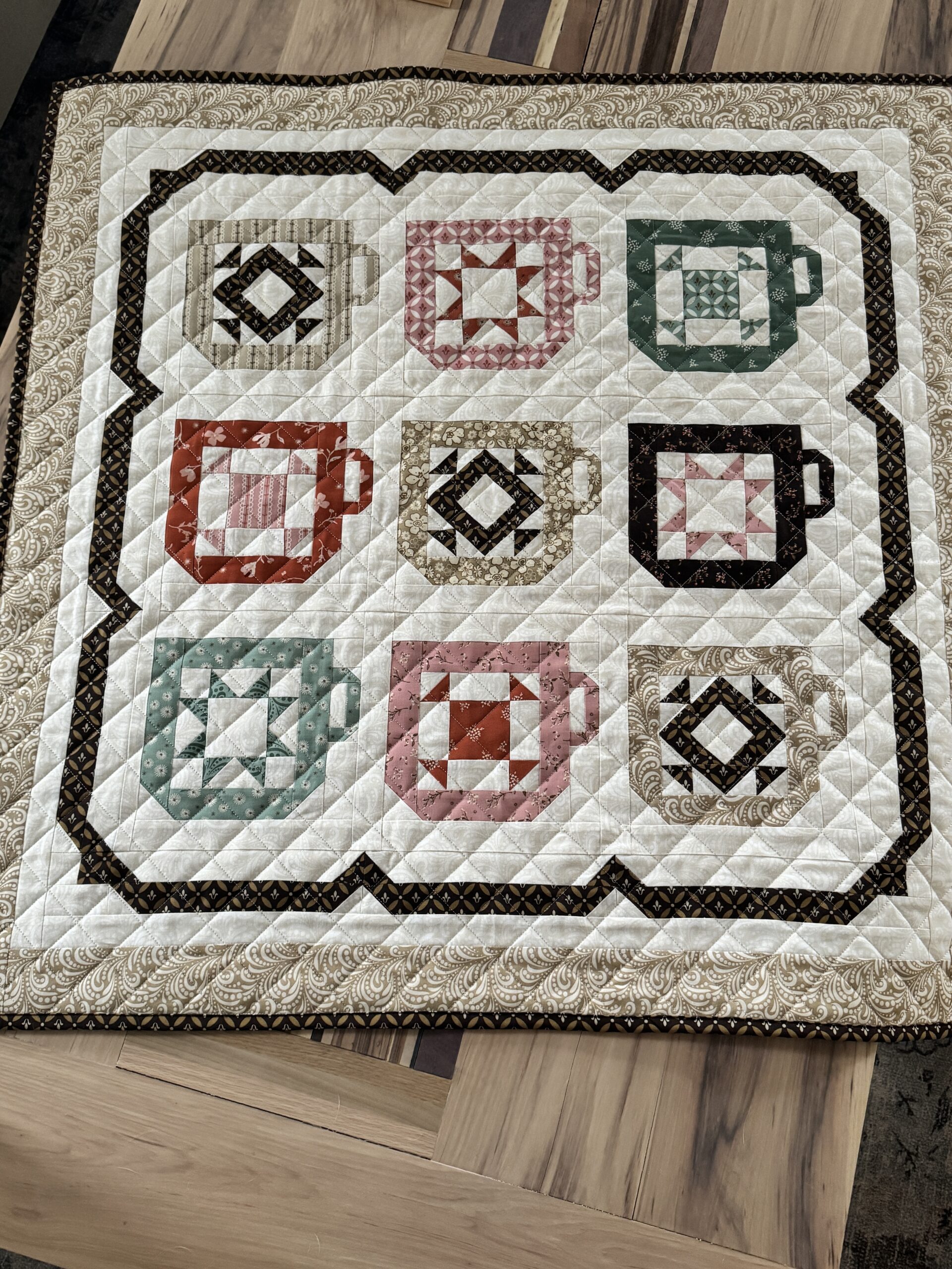 Overhead view of Mug Collection coffee mug quilt laid on a coffee table