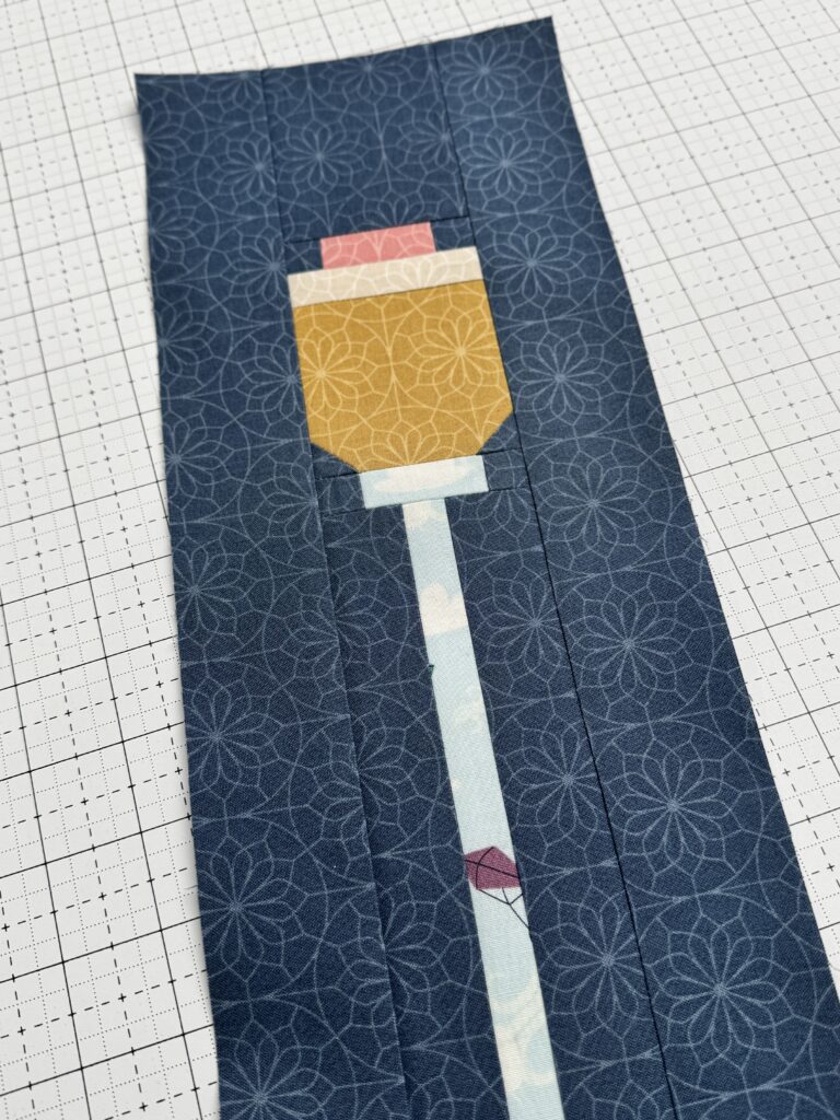 Close up of the top of a lamppost quilt block showing lamp detail