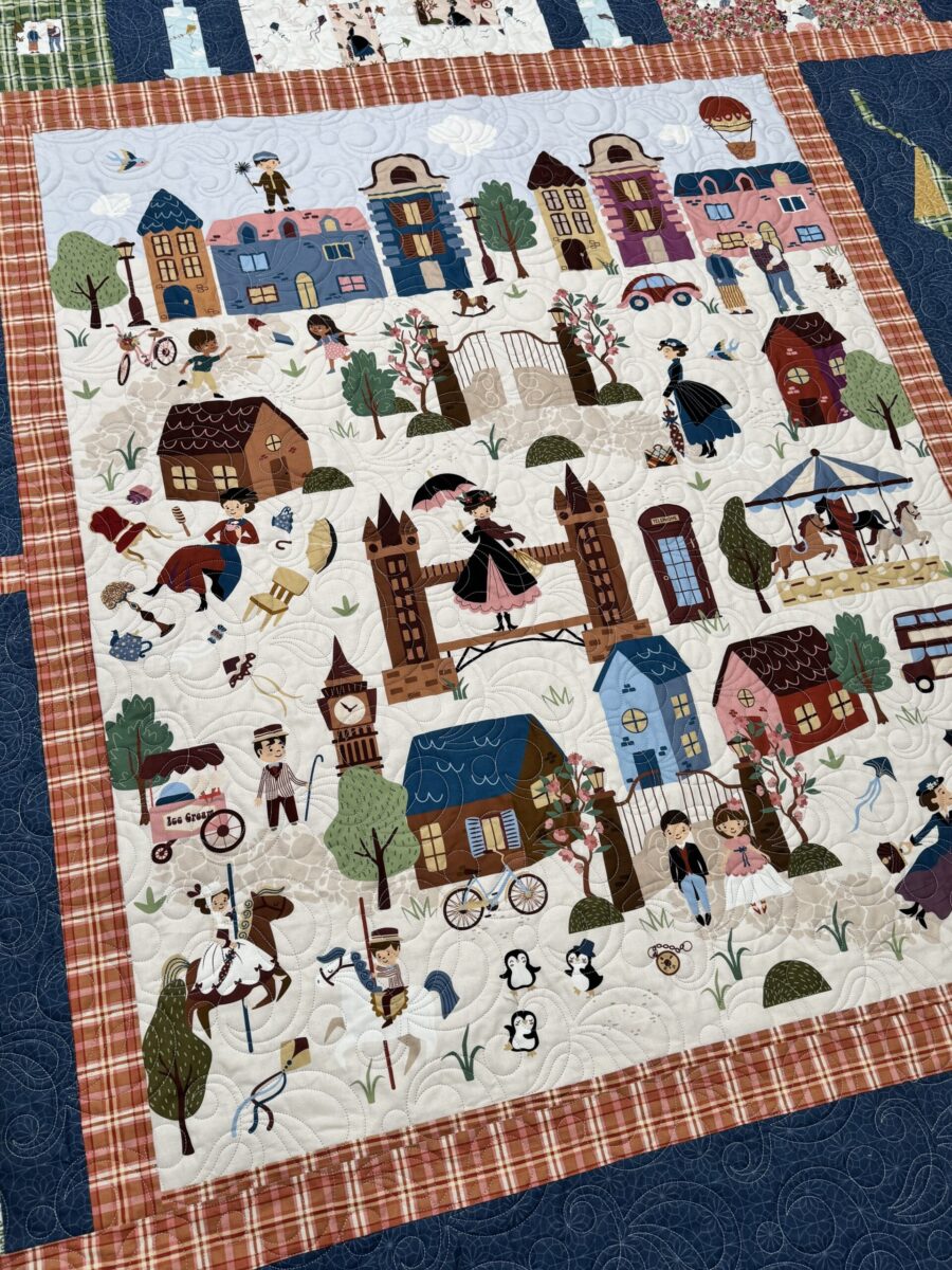 Close up of Mary Poppins panel in finished quilt with surrounding sashing and blocks