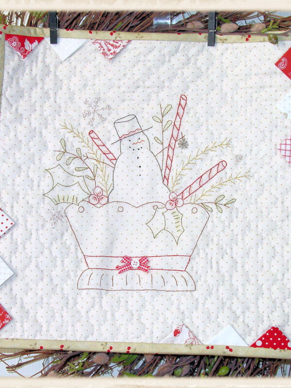 Christmas Basket mini quilt pattern by Plumcute Designs featuring embroidery, prairie points, and snowflake charm