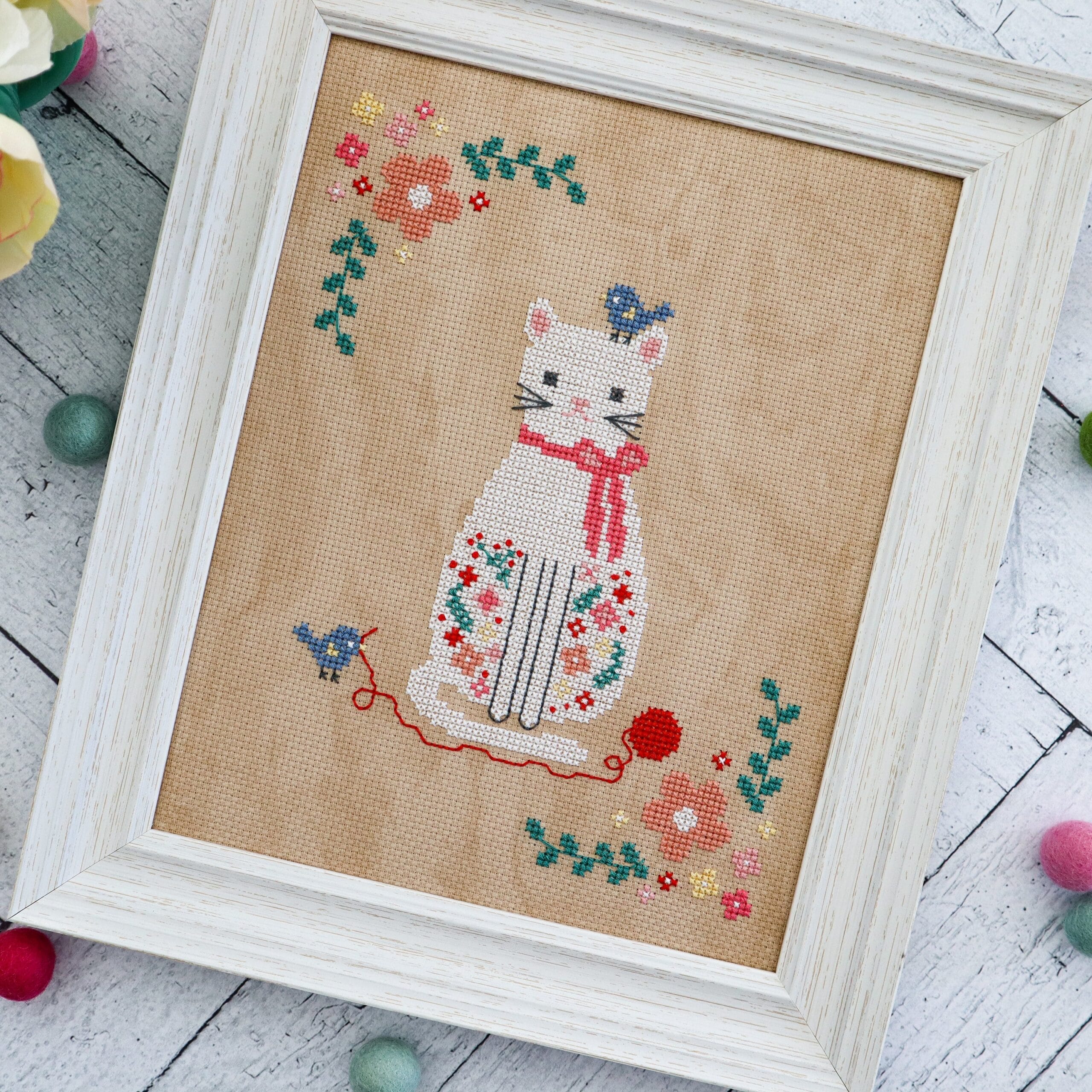 Stitching Friends floral cat cross stitch pattern with white cat bluebirds and flowers