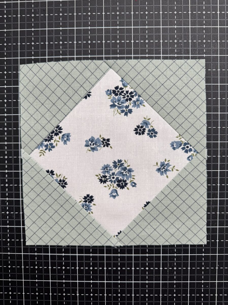 Completed square-in-a-square quilt block with a center square and contrasting corner triangles