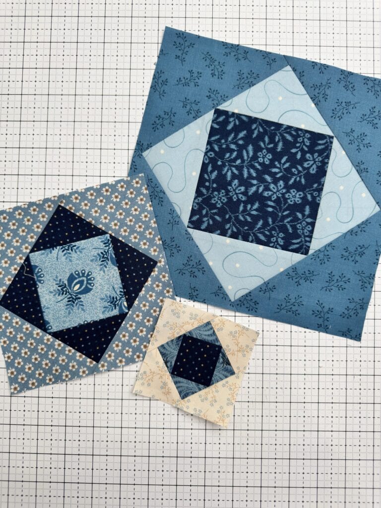 Three completed Economy Quilt Blocks in different sizes.