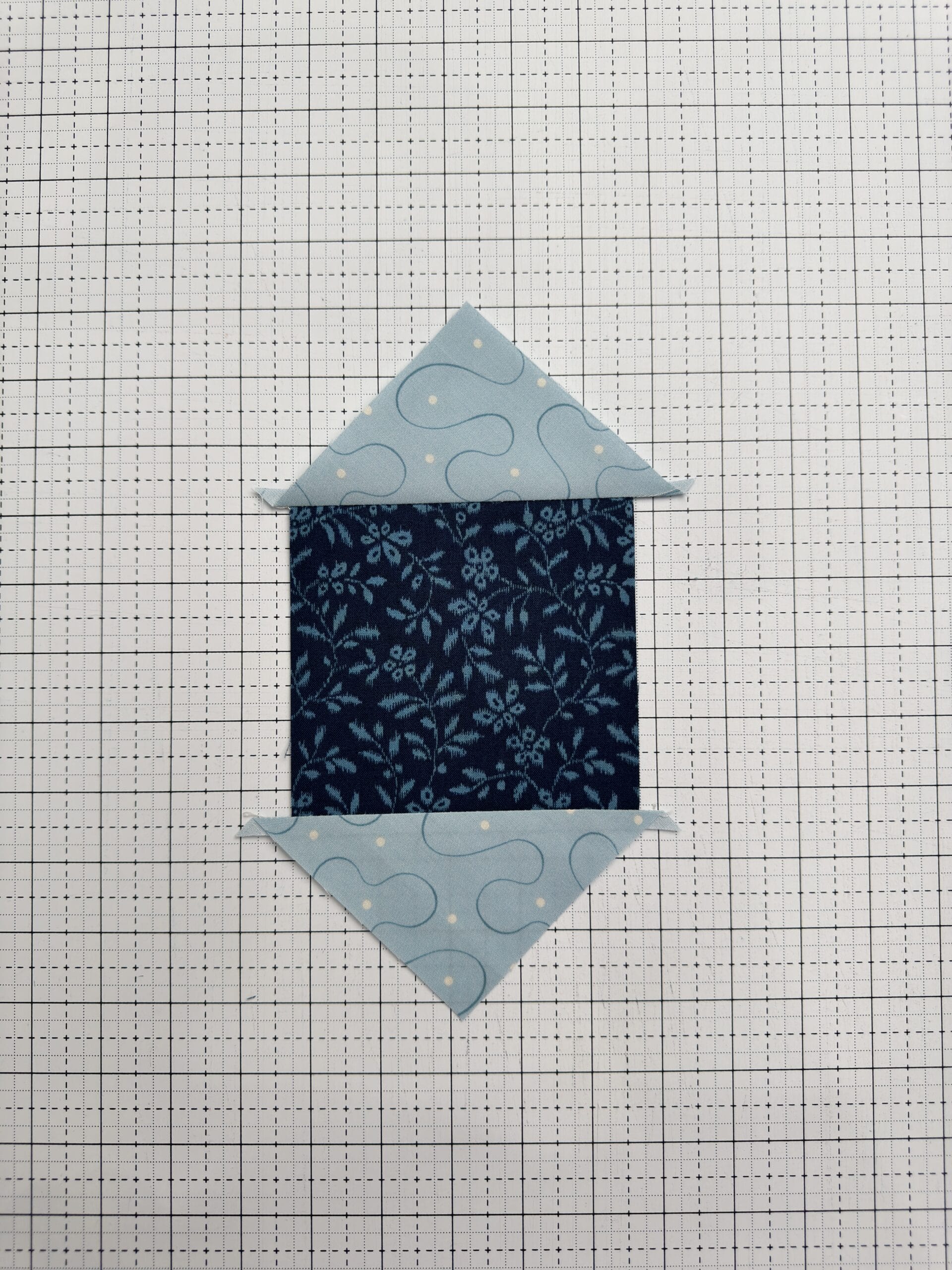 Aligning the first triangles to the center square for an Economy Block