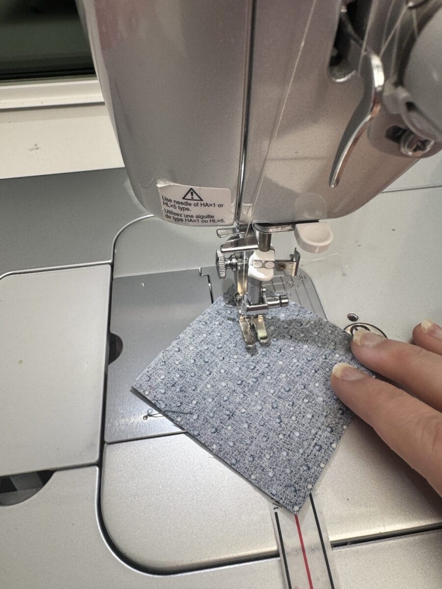 Sewing a diagonal seam on two squares of fabric
