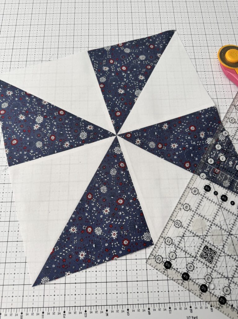 Pinwheel quilt block displayed in a styled quilt photography setting