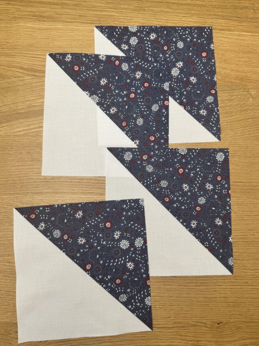 Four half square triangles to use for a pinwheel quilt block
