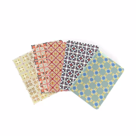 Set of five quilt-themed soft notebooks with gold accents, featuring classic quilt block designs in warm colors on 4x6-inch thread-bound covers.