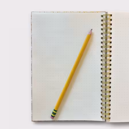 Gold and white spiral-bound A5 sketchbook featuring the Young Man’s Fancy quilt pattern, 80 dot grid pages, perfect for sketching and quilting design.