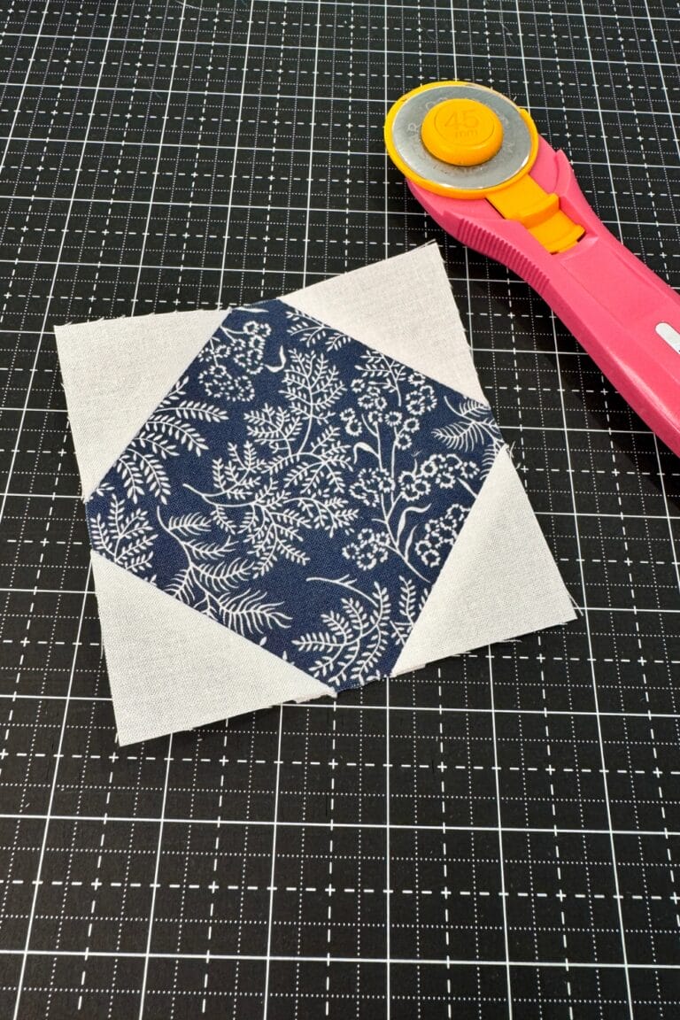 Finished Snowball block with blue center and white sew and flip corners