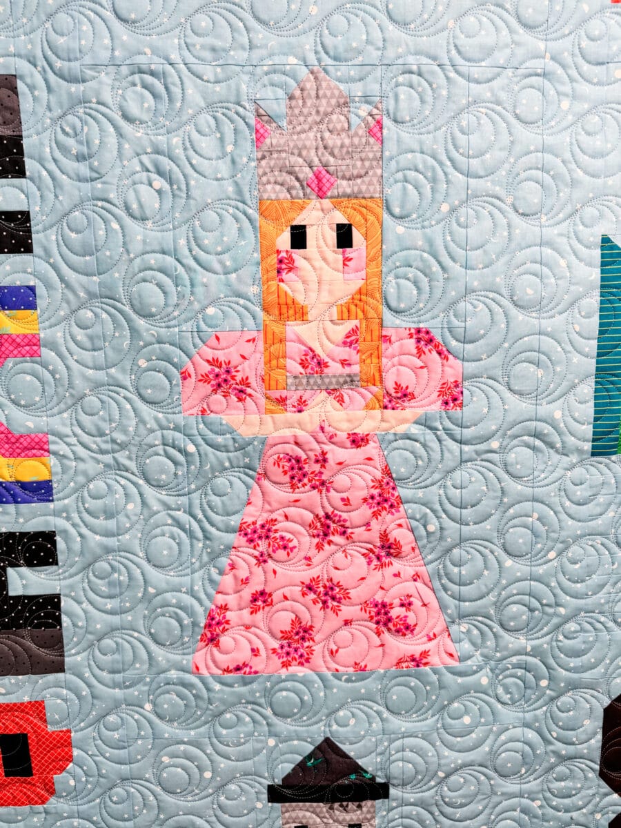 The Good Witch quilt block with a pink floral dress.
