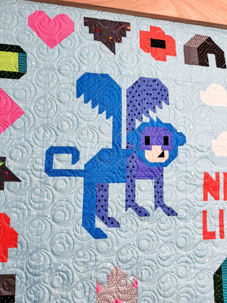 Flying Monkey quilt block featuring a blue monkey with wings.