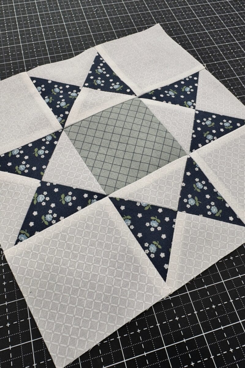 Completed Ohio Star quilt block made in Navy, white, and sage.  