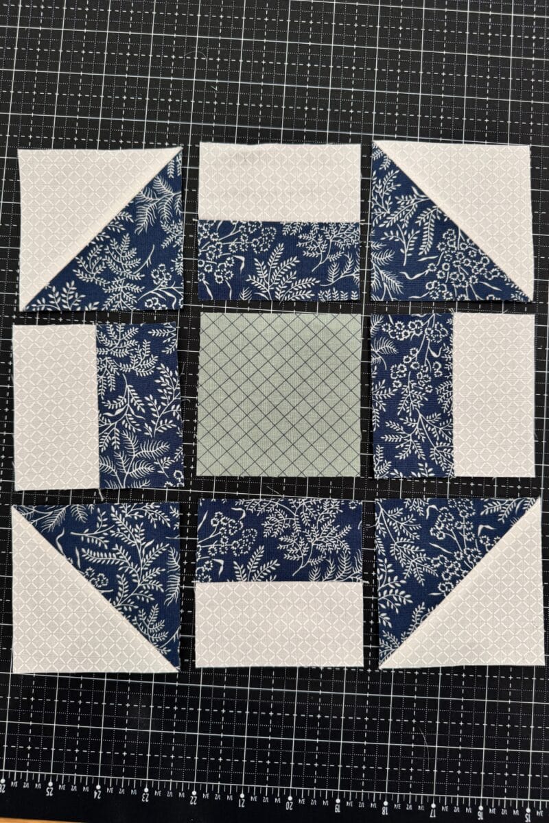 Layout of churn dash block units.  The nine units consist of half square triangles in the corner, strip pieced squares (2 rectangles) on the sides, and a solid center square.  