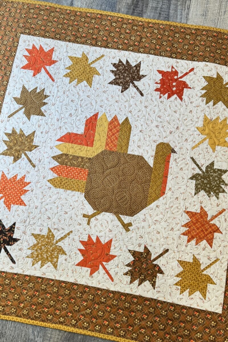Pieced turkey in the center of the Autumn Hues quilt