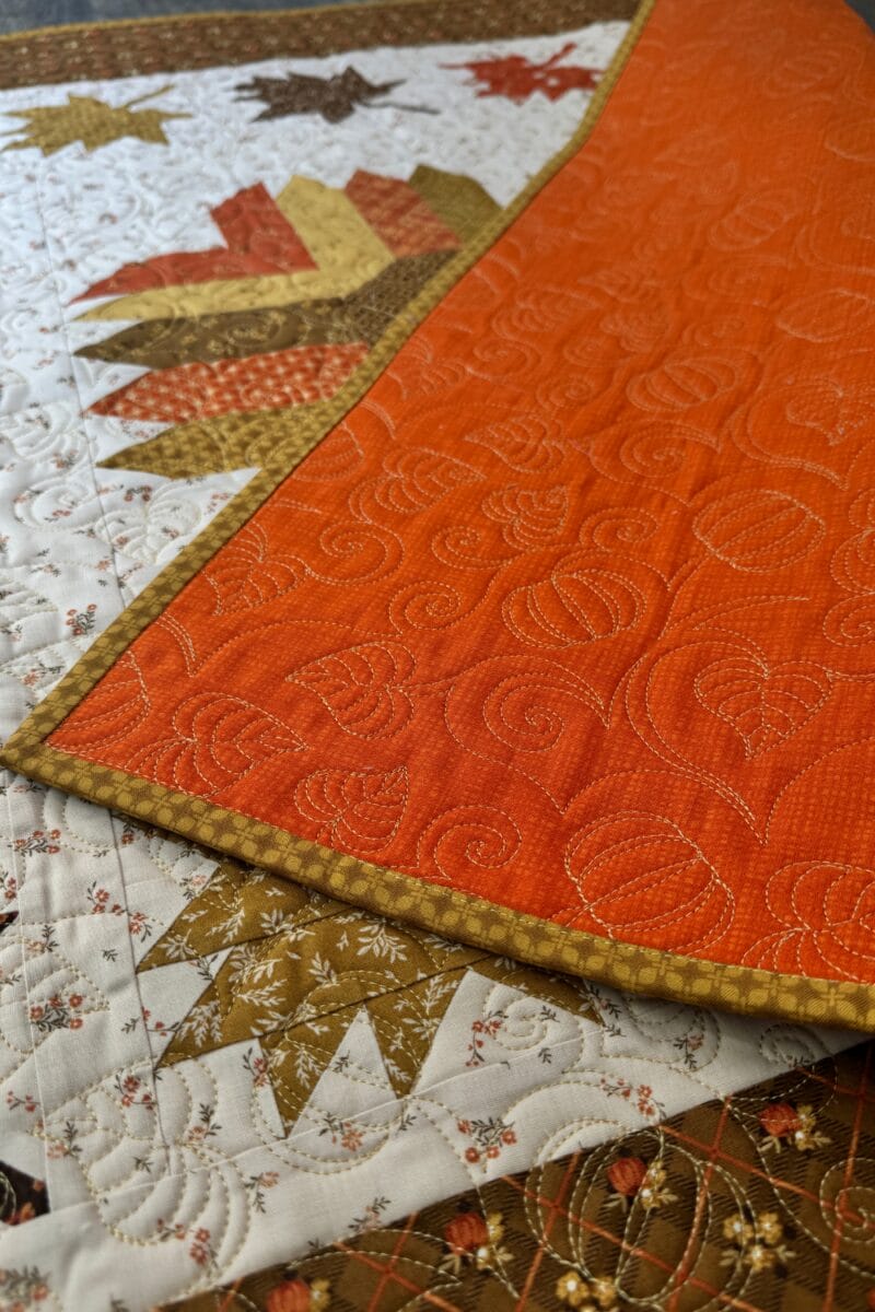 Autumn Splendor quilting on pumpkin backing of Autumn Hues quilt