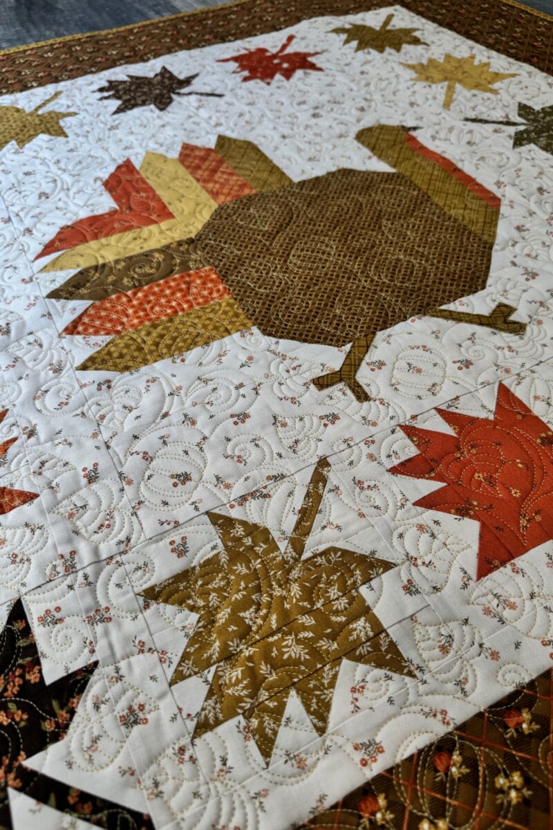 Autumn Hues quilt with turkey and fall leaf blocks