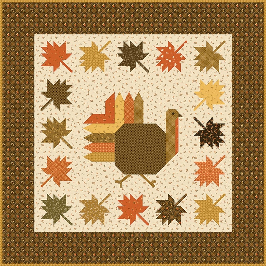 Autumn Hues quilt image featuring a turkey in the center surrounded by fall leaves.