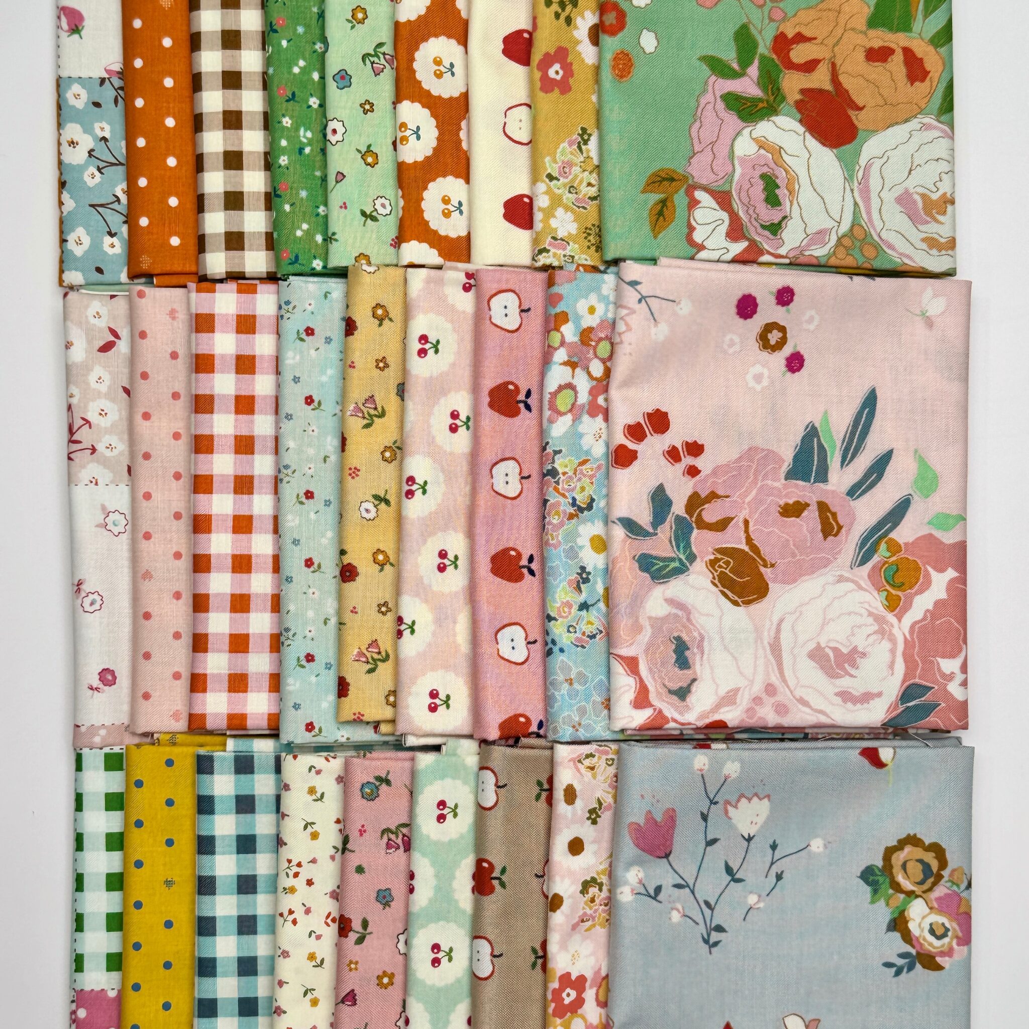 Various fat quarters of the Cotton Nook fabric collection by Minki Kim