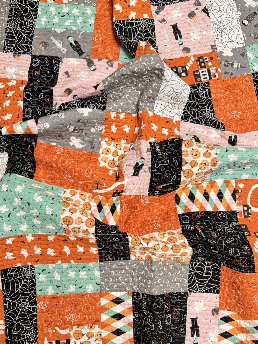 Scrunched Yellow Brick Road quilt showing colorful Halloween fabrics and quilted texture