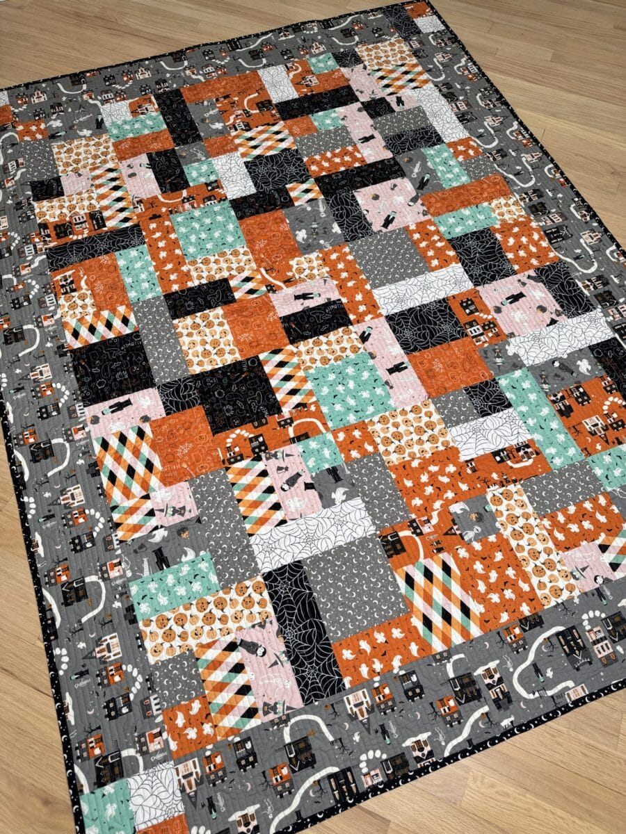Finished Yellow Brick Road quilt made with colorful Frank & Friends Halloween fabrics