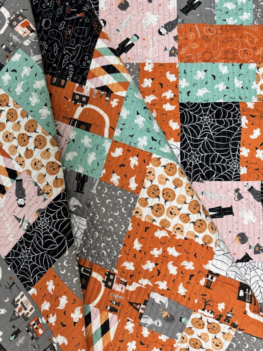 Spooky Road Halloween quilt folded to show the scrappy patchwork design