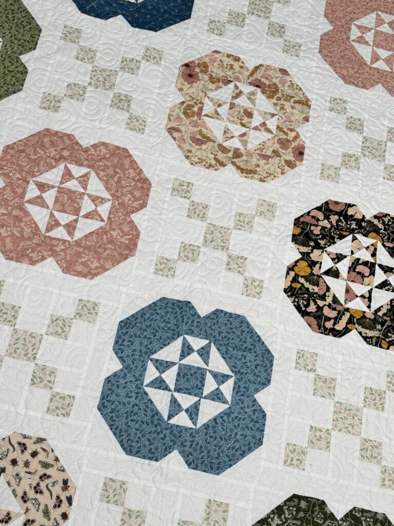 Angled view of Gardenia quilt blocks made with colorful Petalush fabrics