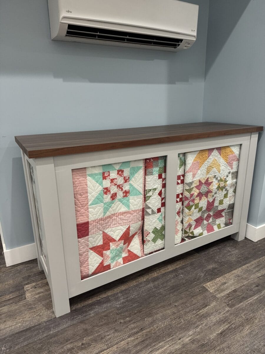 Quilt Display Cabinet against a blue wall